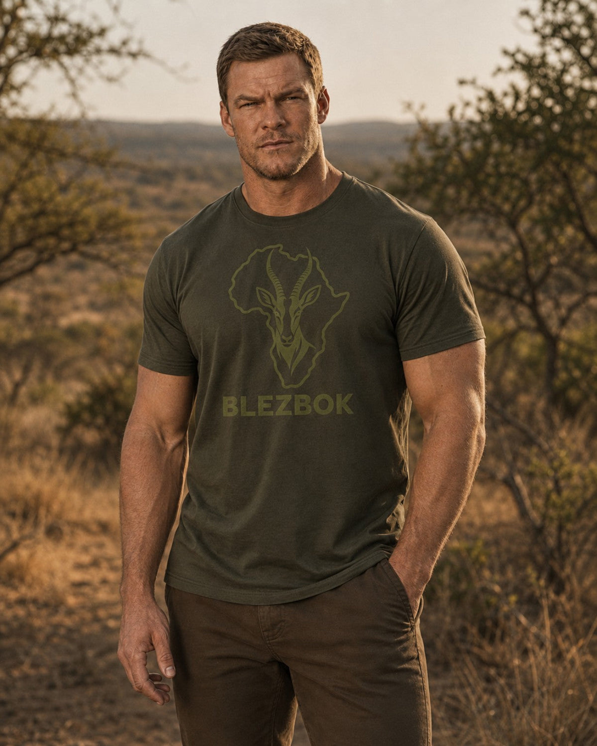 Man wearing an olive Blezbok logo T-shirt outdoors